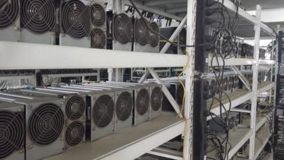 A large-scale cryptocurrency mining farm with rows of mining rigs