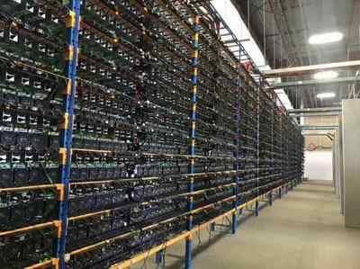 A sprawling Bitcoin mining farm with rows of mining rigs in an industrial setting
